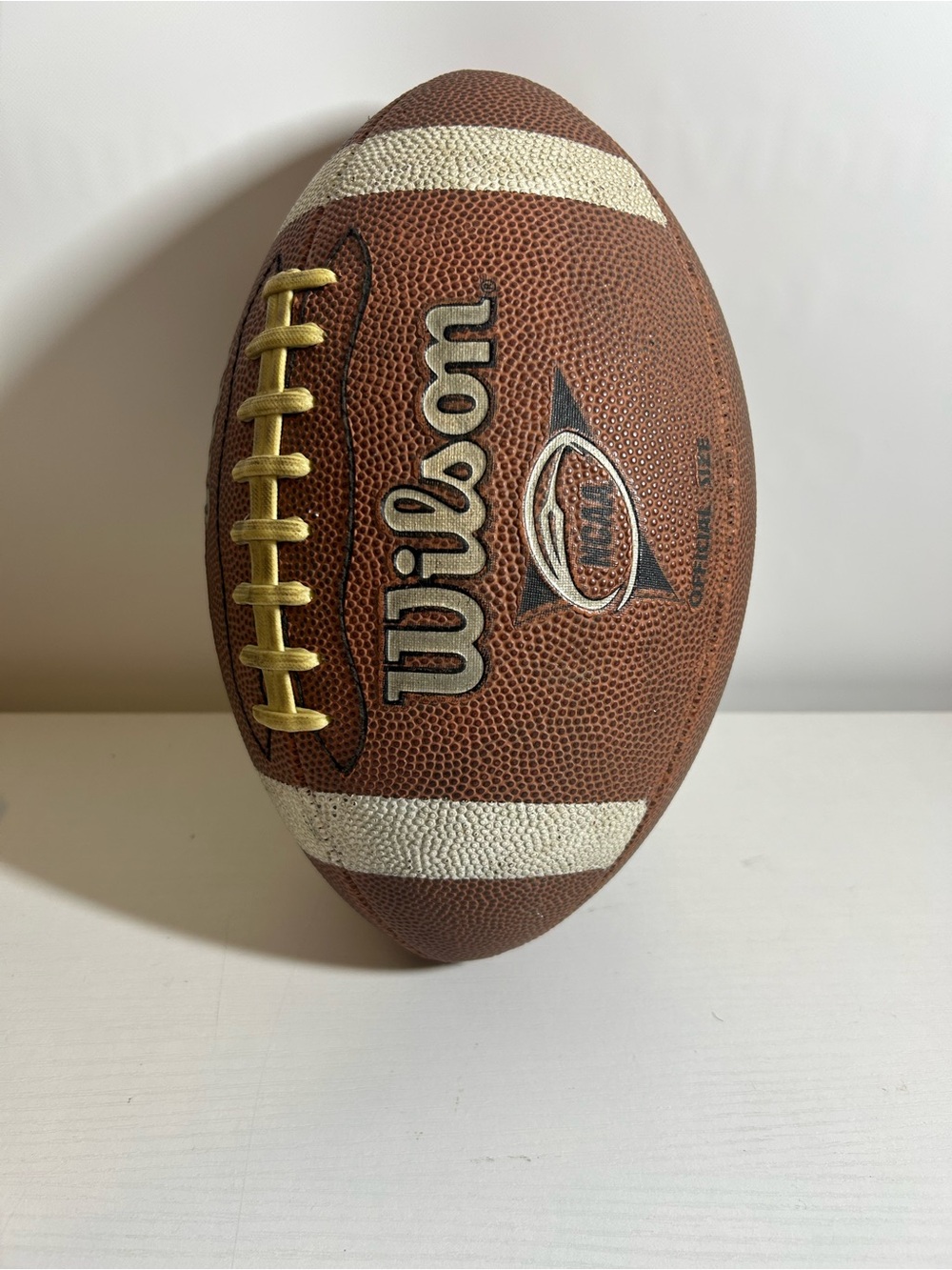 Wilson Brown Football with White Stripes and Gold Laces